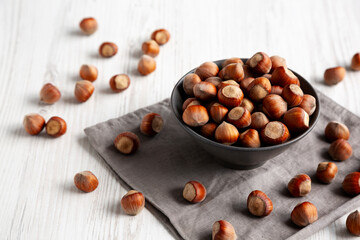 Organic Raw Hazelnuts in a Bowl, side view.
