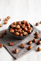 Organic Raw Hazelnuts in a Bowl, side view.