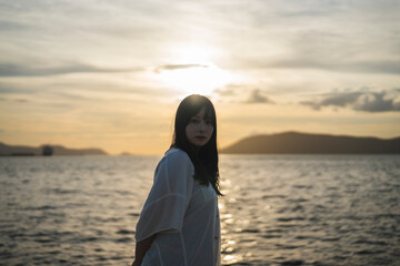 夕日の海にいる女性