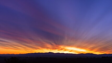 Fototapeta premium Dramatic sunrise with gradient orange and purple clouds, creating a panoramic abstract sky view.