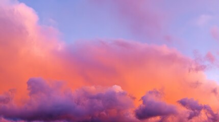 Dramatic sunrise with gradient orange and purple clouds, creating a panoramic abstract sky view.