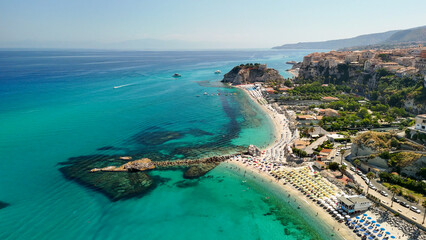 Aerial overhead view of Tropea beach with turquoise sea and sun umbrellas in Calabria
