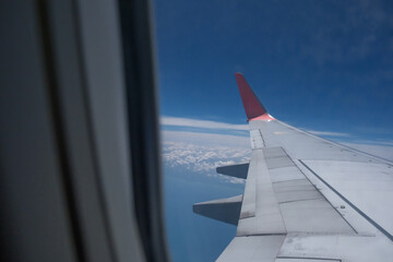 view from a window of air plane when flying on the cloud with air plane's wing outside
