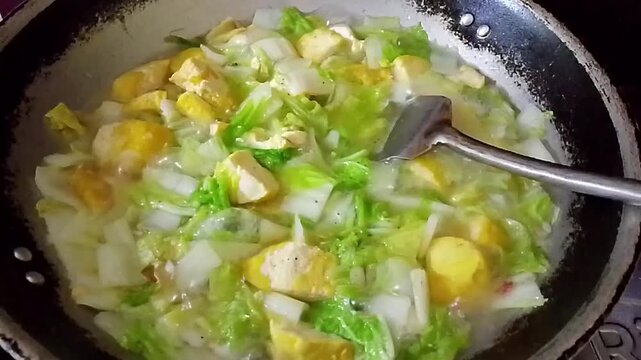 Cooking Asian Mustard Greens and Tofu in a Traditional Wok
