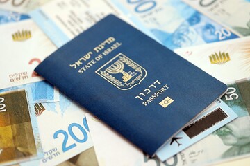 Israel New Shekels banknotes and passport. The current Israel money bills and biometrical pass