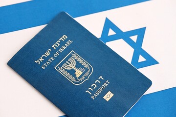 Israel passport on flag. The current Israel biometrical pass lies on flag close up