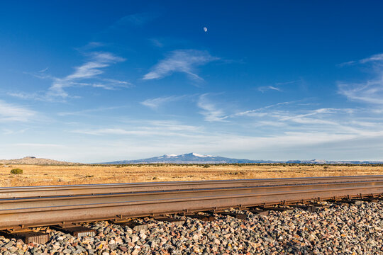 Train tracks cut through beautiful desert environment