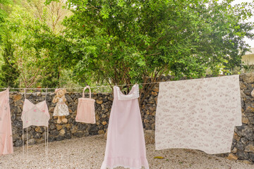 Different clothes drying on laundry line against garden background,clothes hanging laundry on...