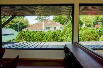 View from the window and the tree in summer,roof of house,cozy indoor home living room.