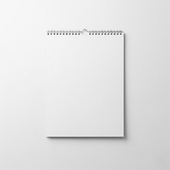 Blank wall calendar with spiral binding on white background