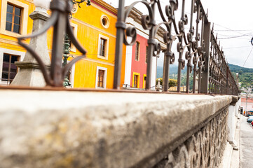 Colonial facades behind wrought iron fence