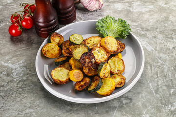 Roasted young zucchini in the plate