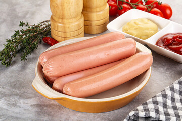 Boiled sausages with ketchup and mustard