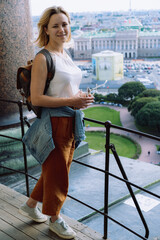young woman against city panorama. Rooftop view