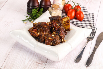 Prepared tasty beef ribs with sauce