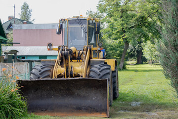 Heavy machinery operates on a sunny day in a serene rural setting enhancing the landscape's transformation