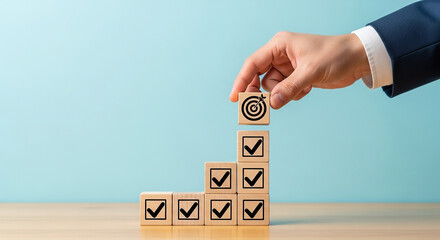 Hand placing wooden cubes with check marks representing progress planning success and step by step checklist verification in business
