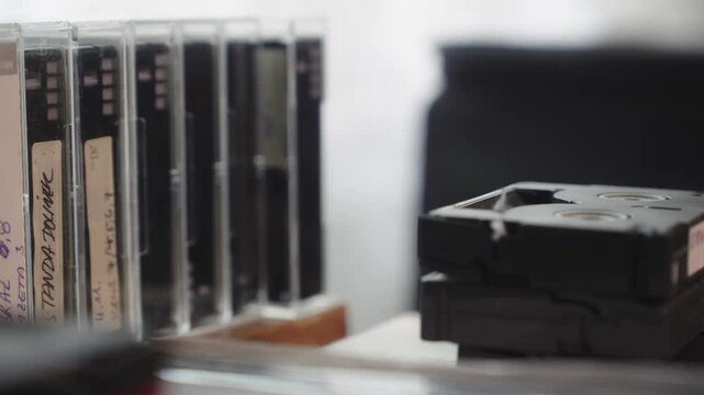 Pull shot reveals collection of home media digital video cassettes