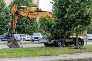 ellow Excavator on Urban Roadside