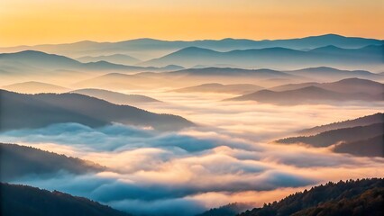Obraz premium Majestic mountain range shrouded in soft morning mist with golden sunrise illuminating the sky above