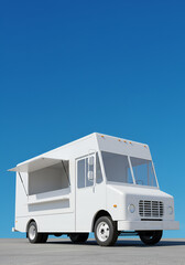White food truck against a clear blue sky