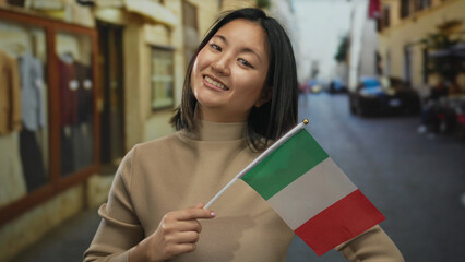 Woman smiling in an italian street holding an italian flag, representing cultural connection in a...