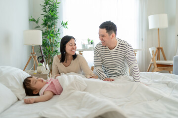 Asian mature parents lovingly care for and raises baby girl at home. 