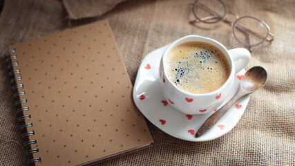 cup of coffee on a simple background, cozy home, notebook and coffee, coffee beans, flatlay, background