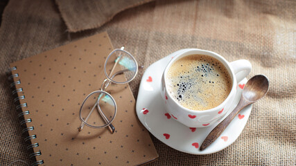 cup of coffee on a simple background, cozy home, notebook and coffee, coffee beans, flatlay, background