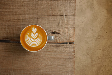  a cup of latte art coffee on wooden background                                                                                                                                                         