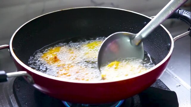 Corn wada is placed in a deep fry pan during the cooking process

A person is placing a prepared corn vada into a hot frying pan filled with oil, showcasing the frying process. 