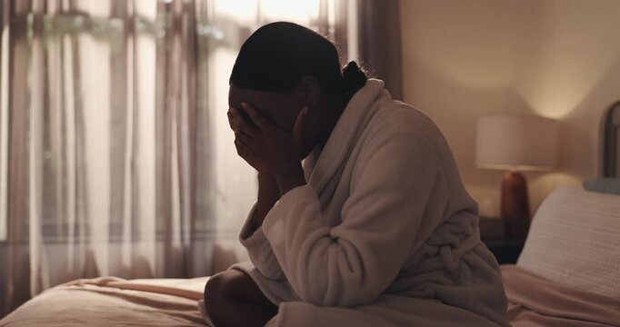 Sad, black woman and crying on bed for breakup, bad news or mental breakdown in home. Female person, emotional or disbelief with grief, divorce or loss in bedroom for depression, anxiety or sadness