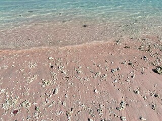 Pink sand and turquoise water at Pink Beach, Komodo National Park, Flores, Indonesia.
