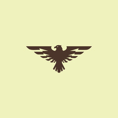 A strong and symmetrical logo of a soaring eagle or falcon with its wings spread wide. This powerful icon symbolizes freedom, ambition, vision, and authority. 