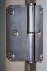 Metal door hinge showing details of the installation and design features in a residential space