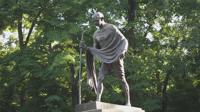 The monument to Mahatma Gandhi in Almaty, surrounded by trees
