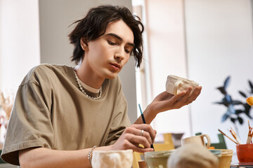 Creative expression in pottery studio with a stylish man crafting unique ceramics