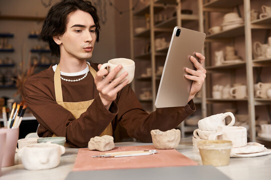 Creative exploration of pottery by a stylish man in a vibrant ceramics studio - Powered by Adobe