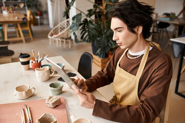 Stylish man immersed in creative pottery work within a bright ceramics studio atmosphere