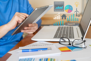 Business analyst evaluating company performance using digital tablet and laptop, with various charts and graphs displayed, representing analysis, finance, kpi, sales, and progress