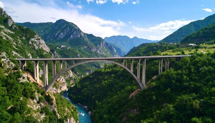 Fototapeta premium Scenic mountain arch bridge over river valley