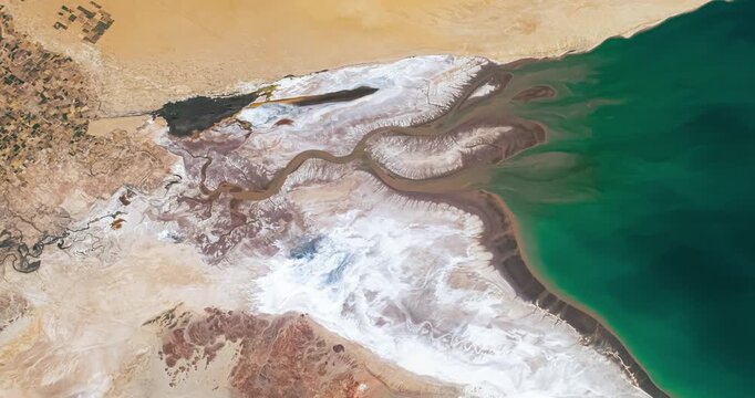Panoramic shot on salty river flowing into a bay in desert region. Camera is moving right and down. Animation based on image by NASA