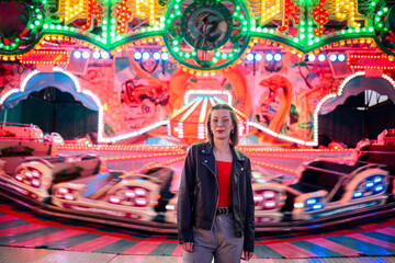 Stylish Woman at Vibrant Carnival Ride in Motion