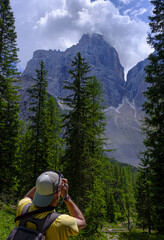 Hiker photographing Mount Pelmo in the Dolomites, Italy.