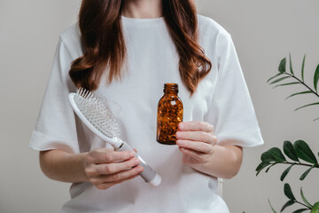 A woman holds omega-3 fish oil capsules. Healthy lifestyle, prevention and treatment of diseases. The woman takes and drinks dietary supplements and vitamins for skin, nails and hair. 