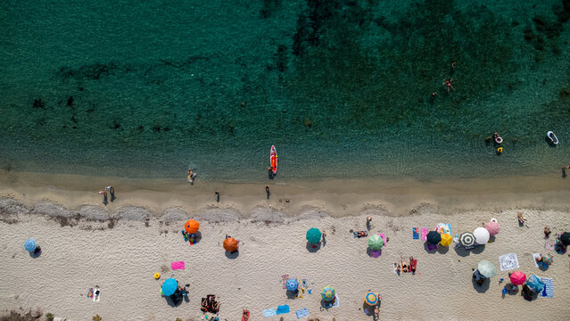 Beach Umbrellas, Swimmers, and Kayak – Aerial View of Mediterranean Summer Leisure in Calabria, Italy