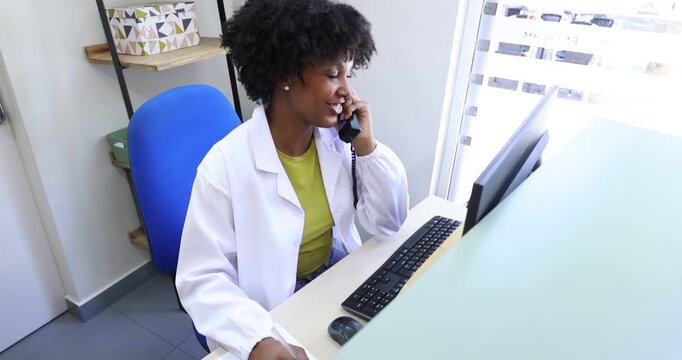 Clinic receptionist handles phone calls, schedules appointments, and manages patient data efficiently