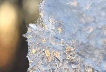 Closeup of ice on the window at sunset. Winter background, ice texture macro 