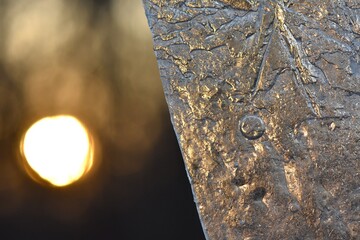 Closeup of ice on the window at sunset. Winter background, ice texture macro 