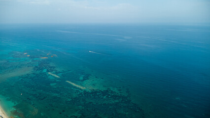 Turquoise Waters, Small Boat, and Coastal Shore – Aerial View of Mediterranean Seascape in Calabria, Italy